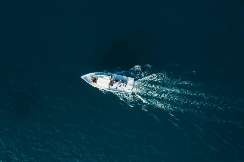 two boats with people riding on the bow in the ocean