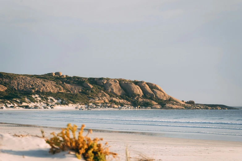 a view of a beach, mountains and water