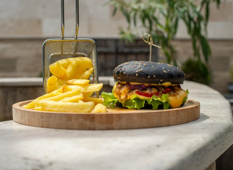 a hamburger, french fries and a soda on a tray