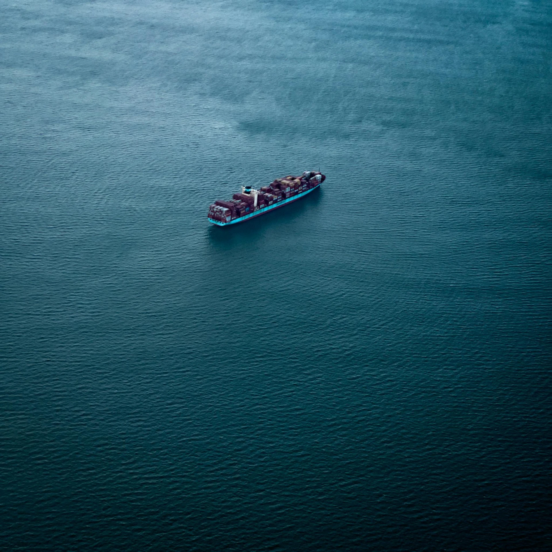 a large cargo ship floating on top of a body of water