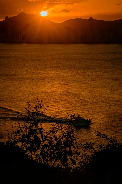 the sun is setting over a body of water