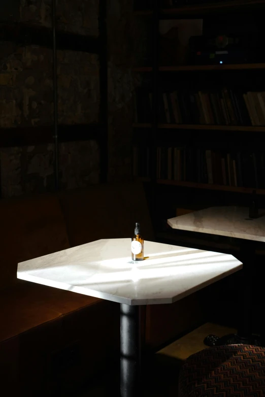 a small bottle sitting on top of a white table