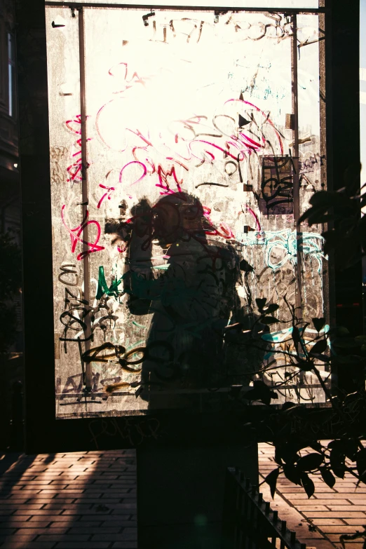 a woman taking a picture through the window