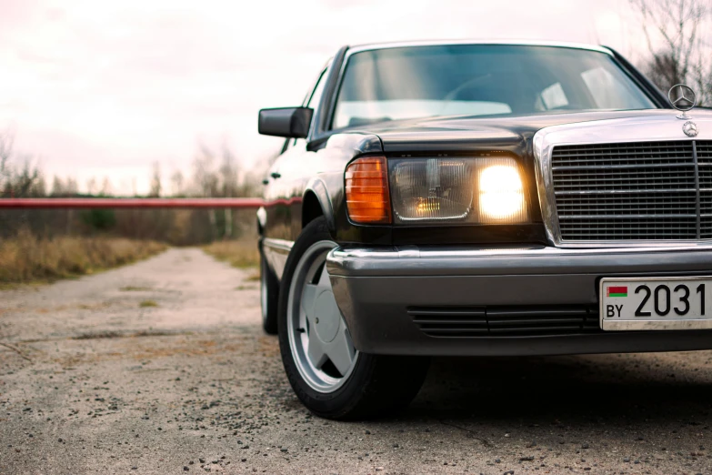 a mercedes benz benz coupe parked next to a road