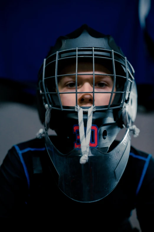 a person is wearing a hockey helmet and making a face