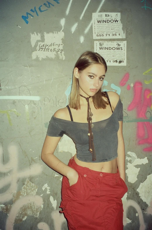 woman posing in front of graffiti wall with neck tie