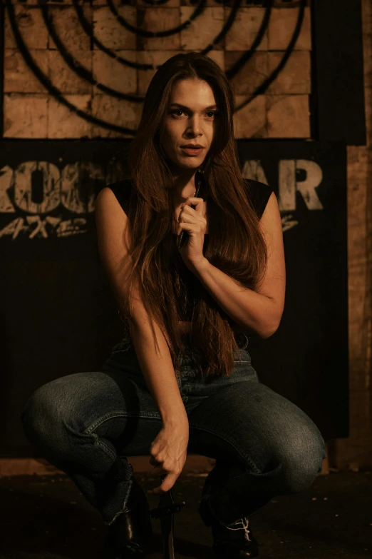 the young woman is sitting down with her hair in low ponytail