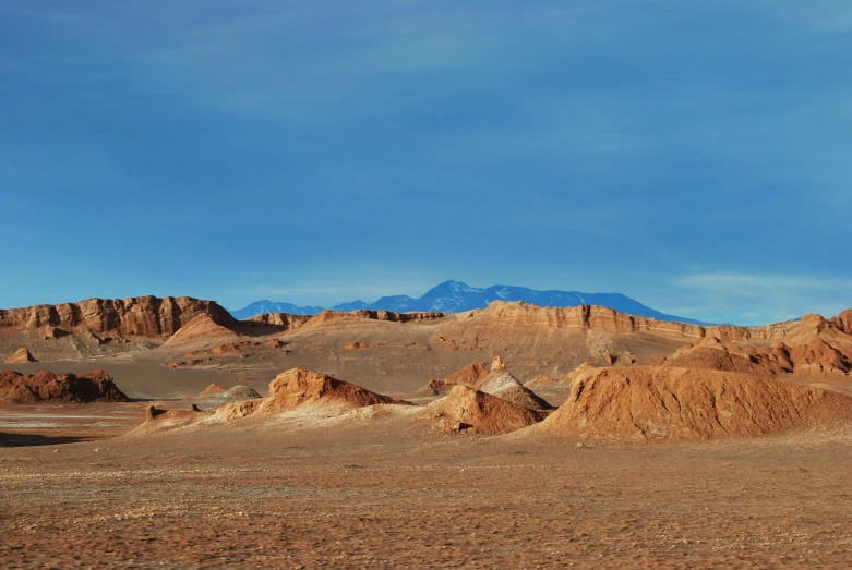 the landscape has many hills and sand at the bottom