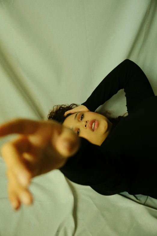 a woman is posing for the camera while lying on her stomach