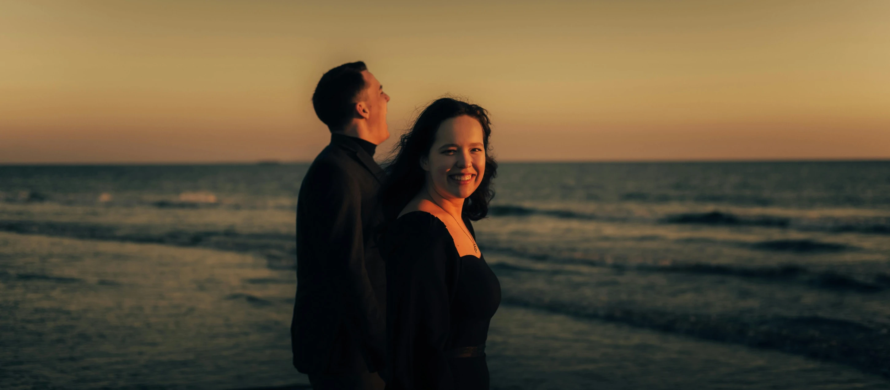 the man and woman are on the beach by the water