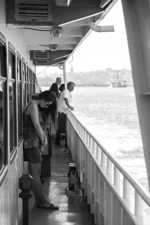 a group of people standing on a platform near the water