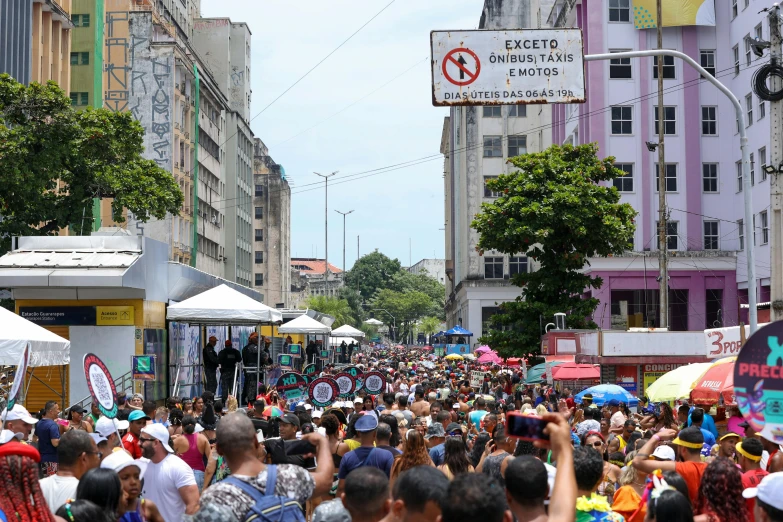 a crowded city street filled with lots of people