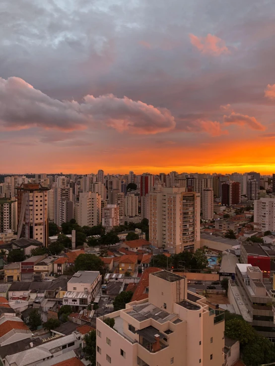 the sky is orange and pink over the city