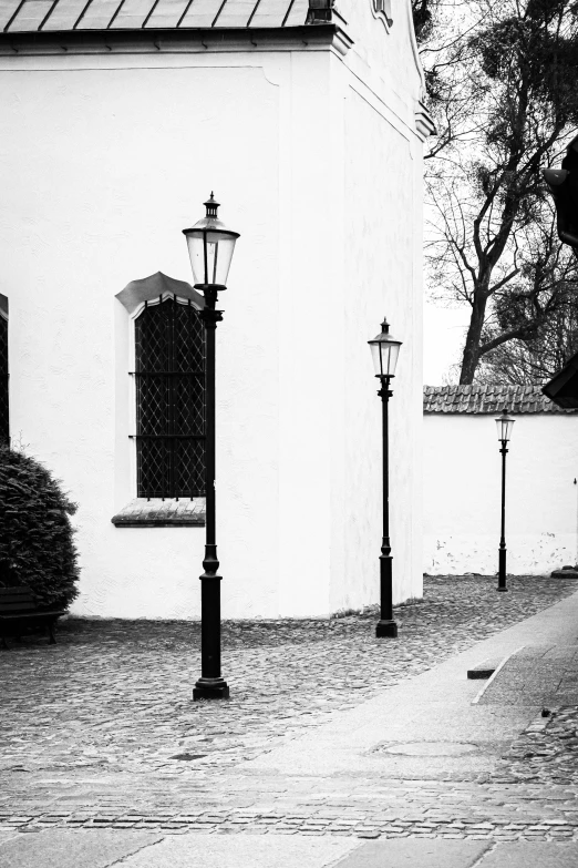 black and white pograph of street lamps and building