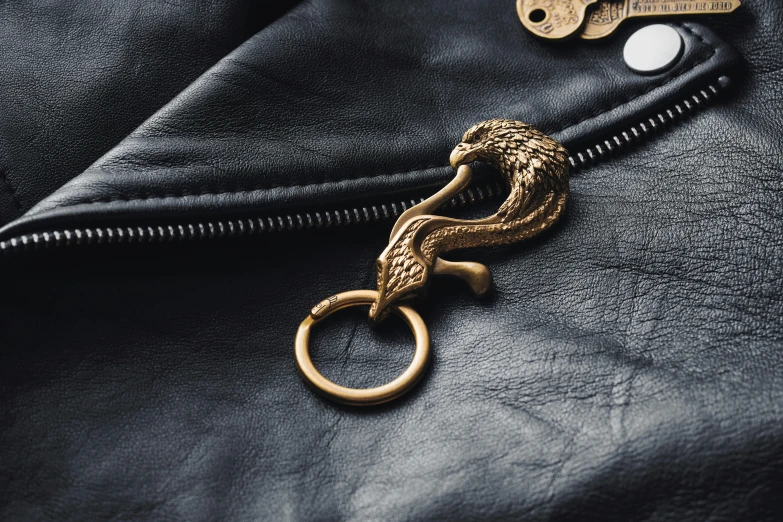 a golden key is placed on the leather jacket