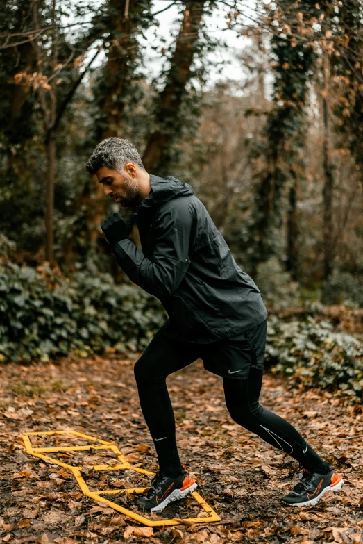 a man running through the woods on a trail