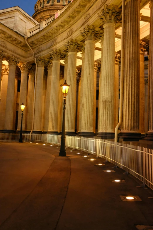 a building with lots of columns and lights on it