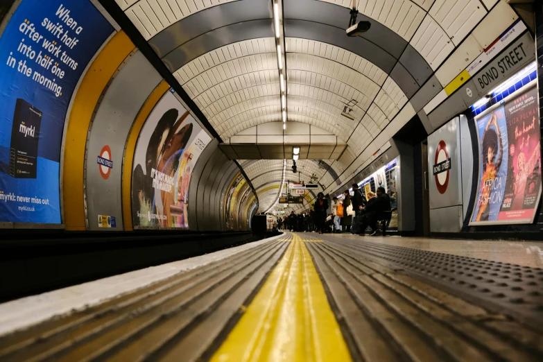 a subway station with people waiting for their train