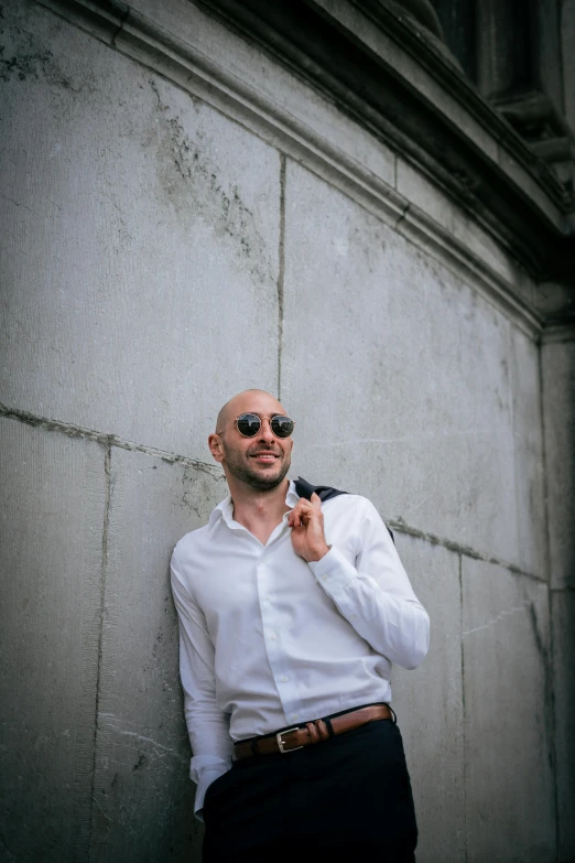 an image of a man leaning up against a wall