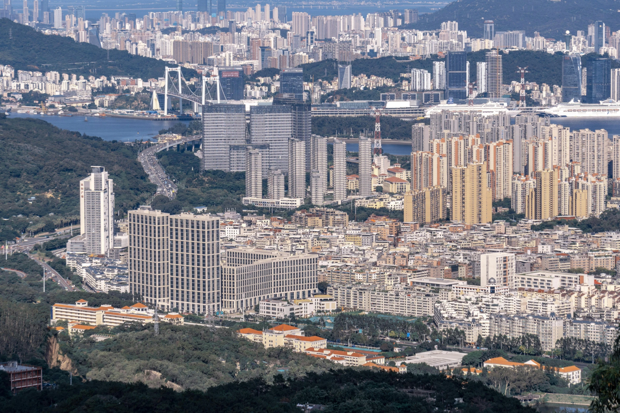 an overview of a very tall city by the water