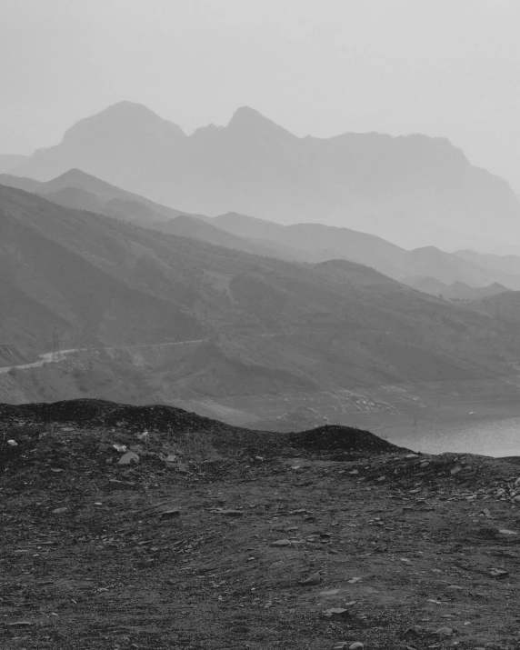 a black and white po of mountains in the fog