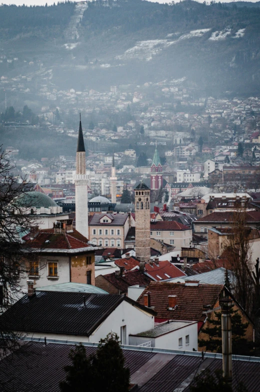 a city filled with buildings next to a hillside