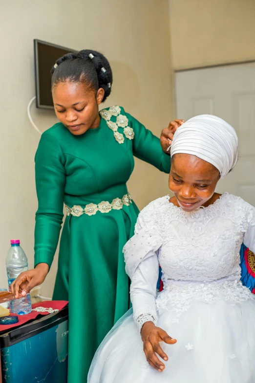 two women standing by each other in their wedding outfits