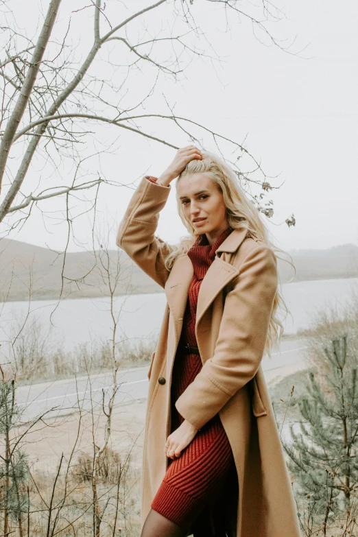 a woman wearing short red skirt and boots posing