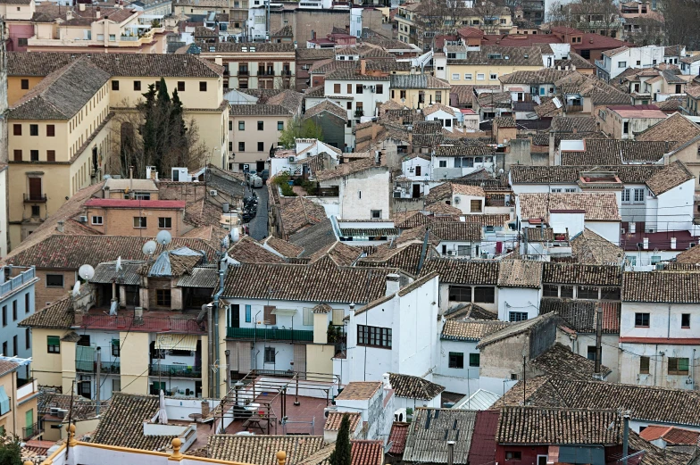 a cityscape shows buildings that include different type of roofs