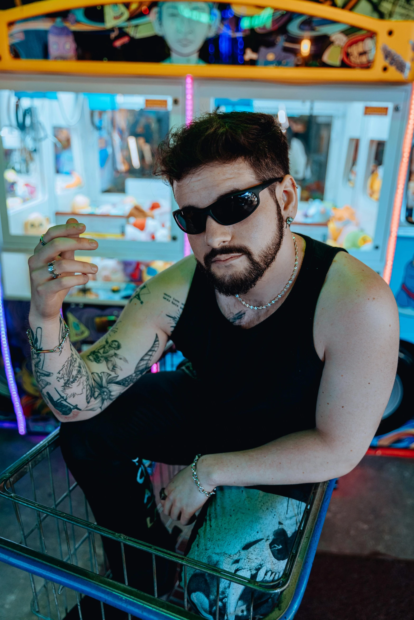 a man sits in front of a carnival machine