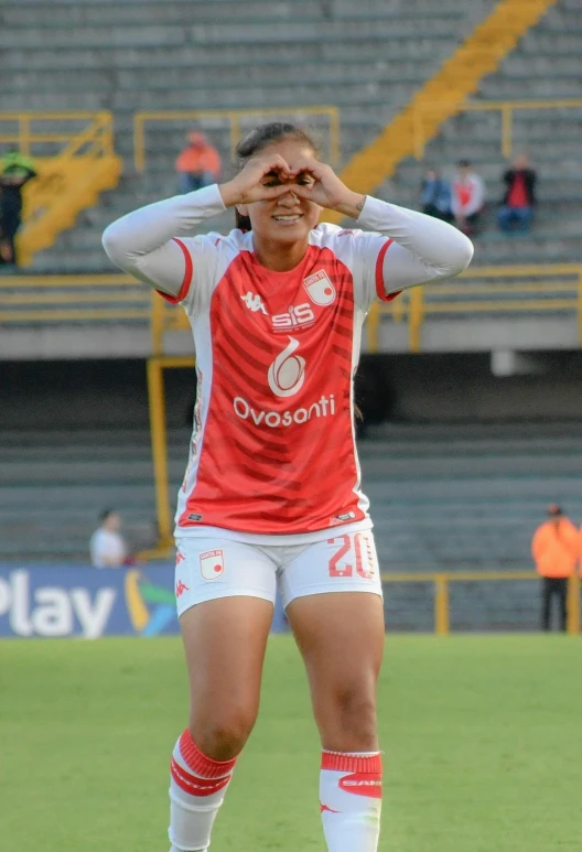 the women's soccer player is covering her eyes