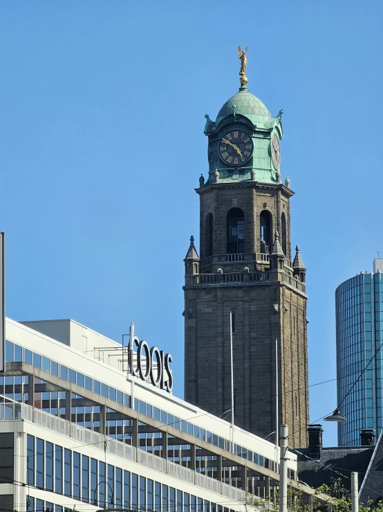 an old brick building with a green steeple and clock