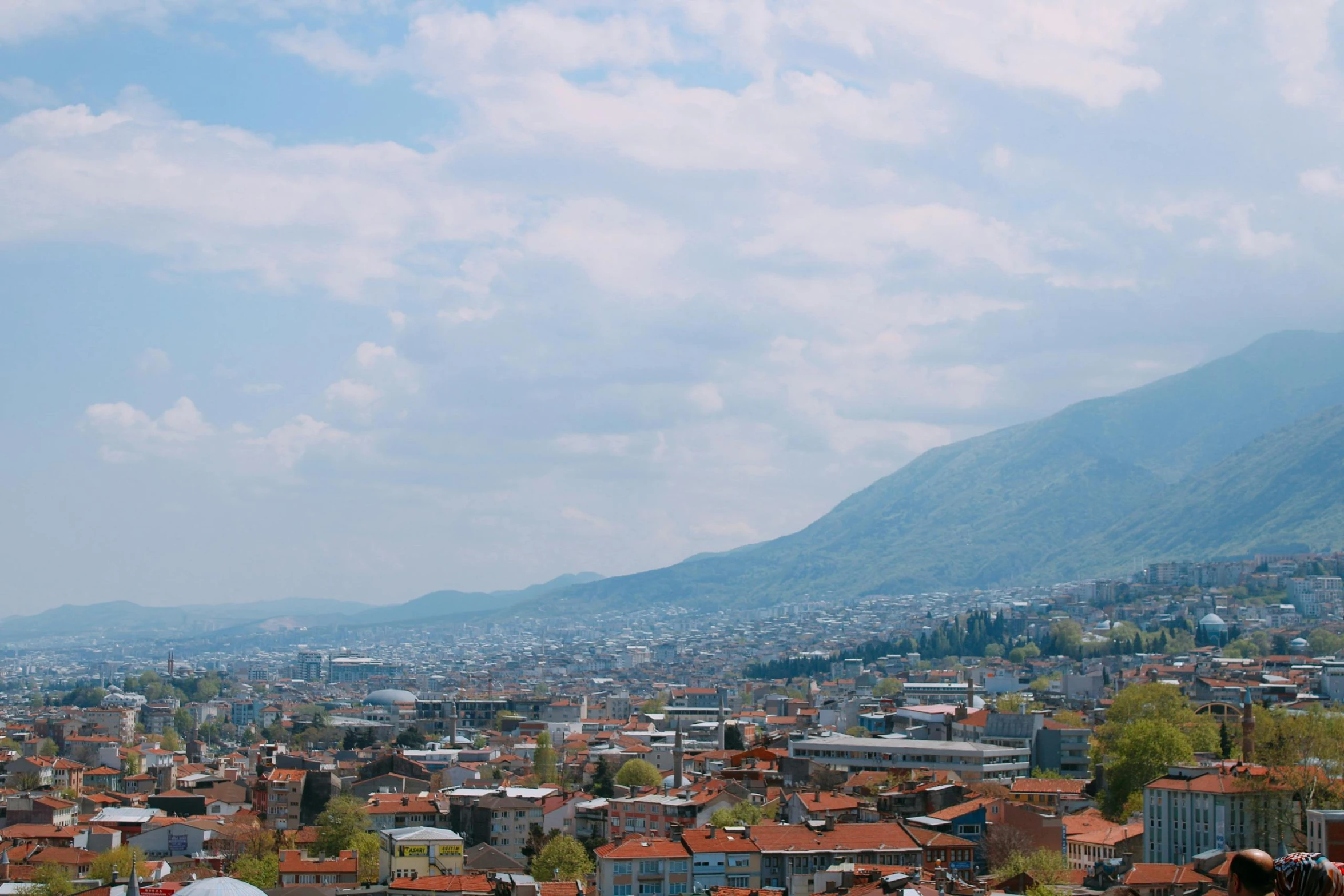 an aerial view of a city and hills