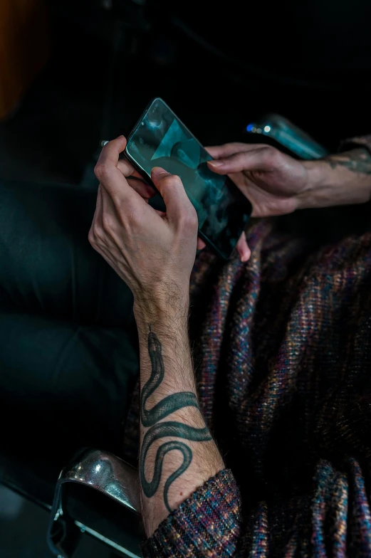 a man holding up his phone to show the camera