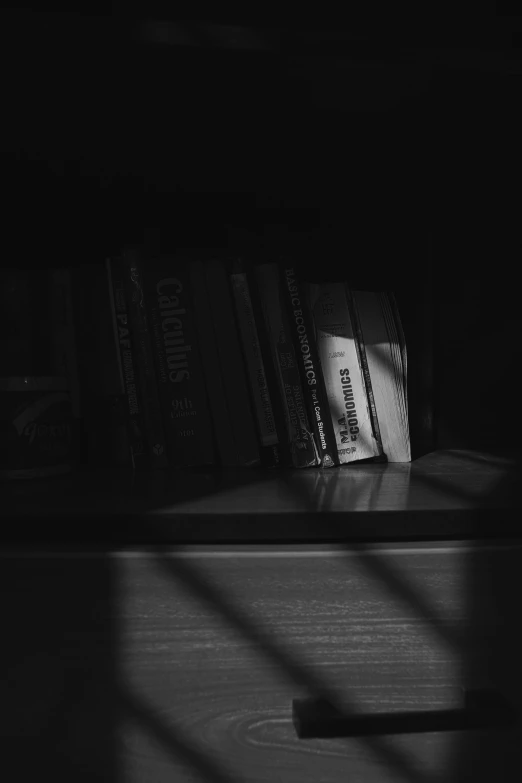 a shelf in the corner has books on it