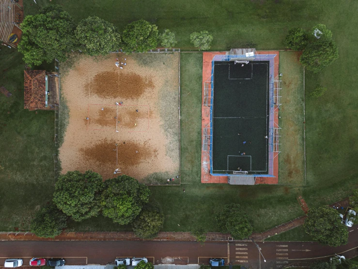 an aerial view of a sports field in the middle of a city park