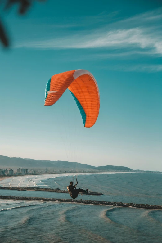 someone parasailing in the ocean with a parachute