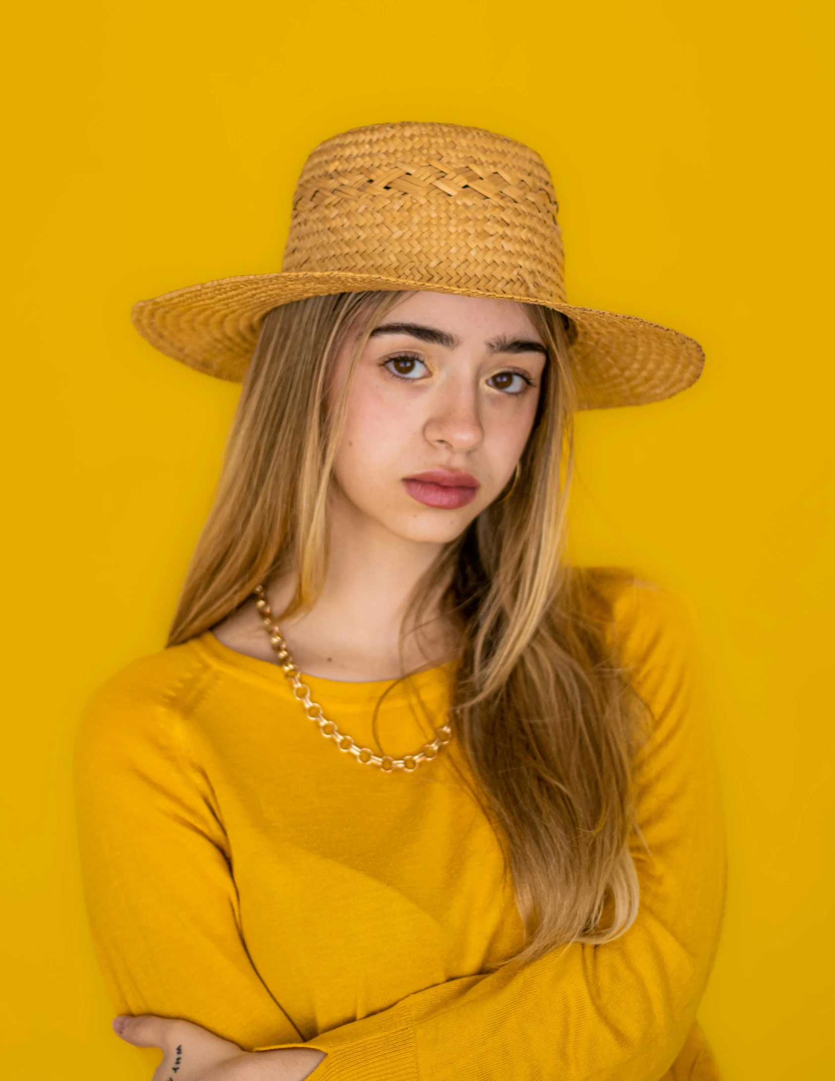 a girl with a yellow shirt and a hat