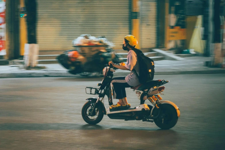 there is a man riding a motorcycle that is in the road