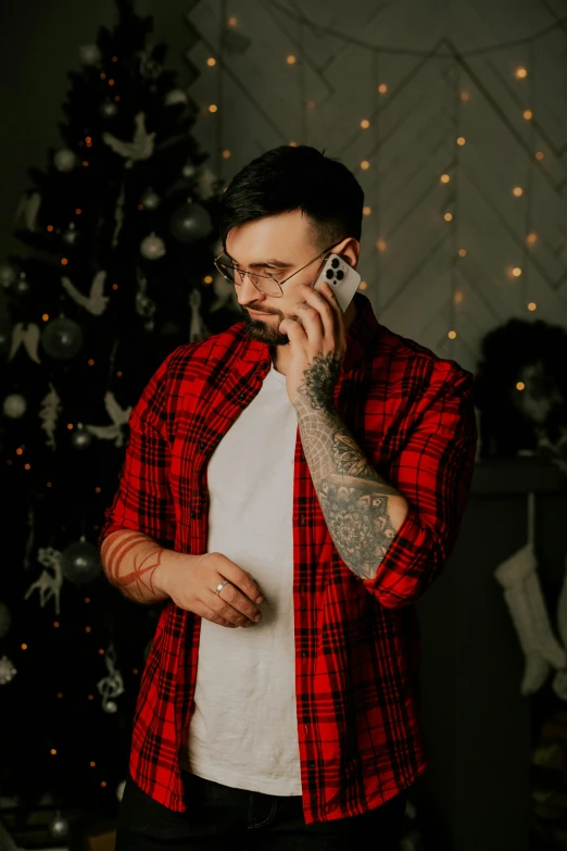 a man in plaid shirt talking on cell phone