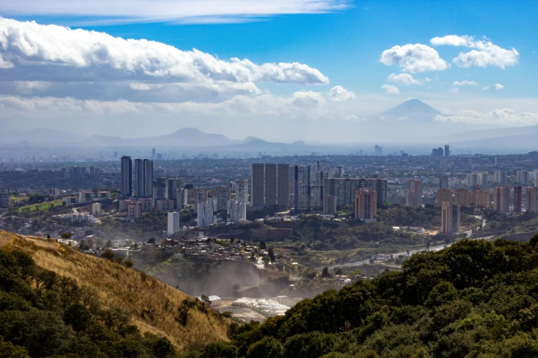 a view of the city with a waterfall below