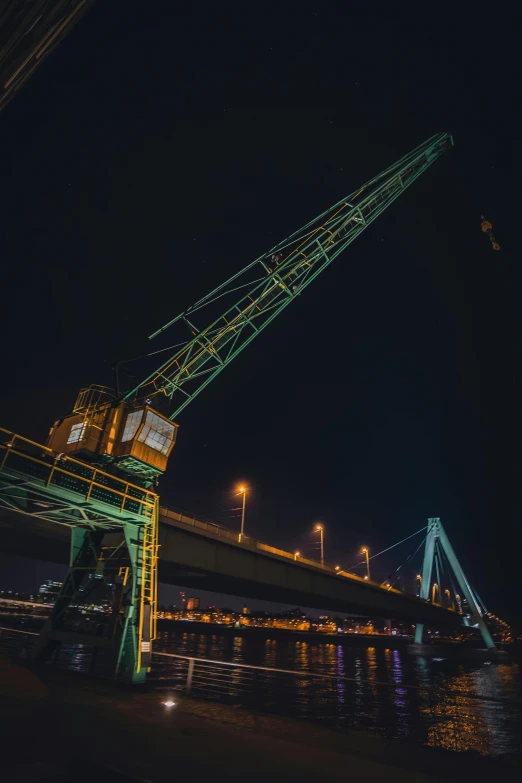 a crane with its lights on that is suspended