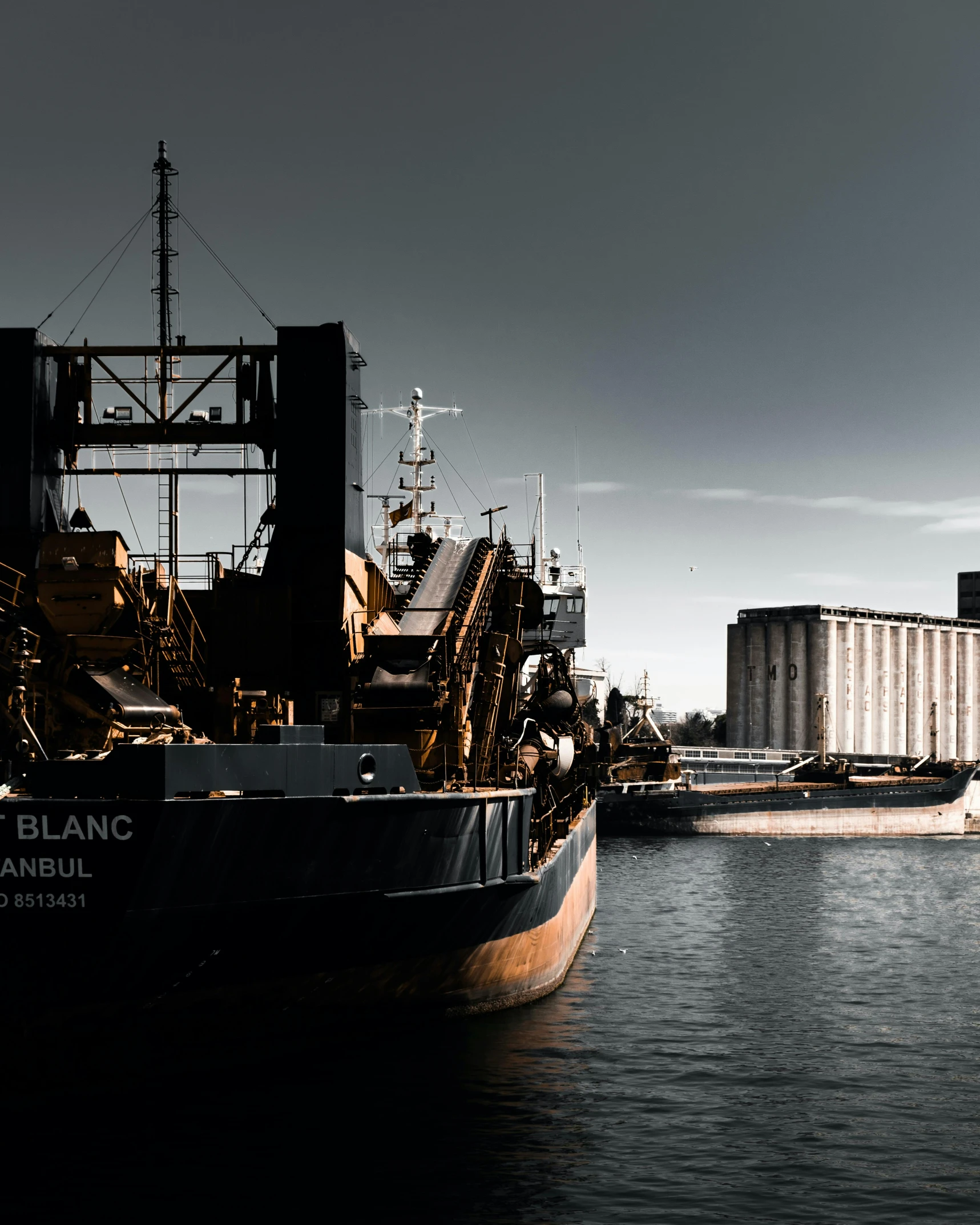 a large cargo ship in the water with some machinery on it