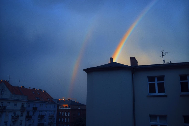 rainbow during a downpour in the night sky