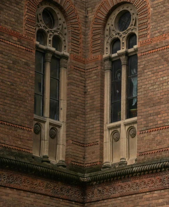 a large brown brick building with double windows