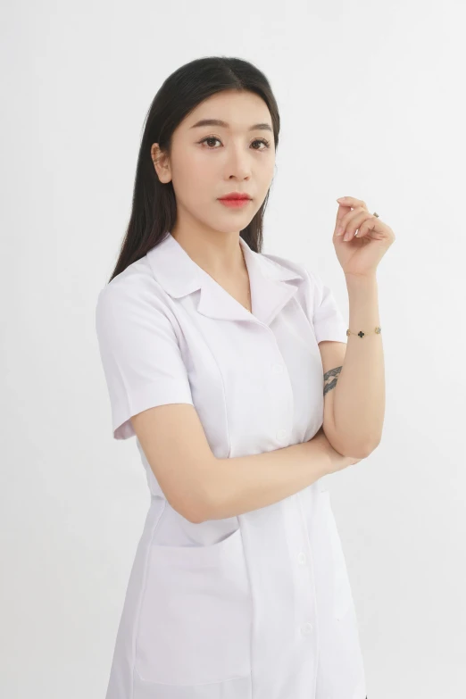 a woman in a white shirt posing with her hand on her hip