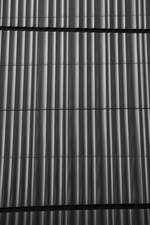 some black and white striped fencing next to a building