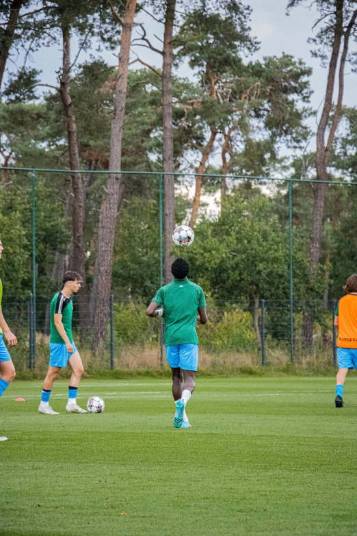 soccer players are competing in the middle of an empty field