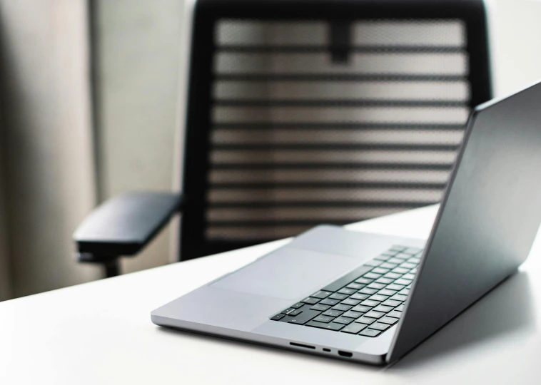 a white laptop is sitting on a table