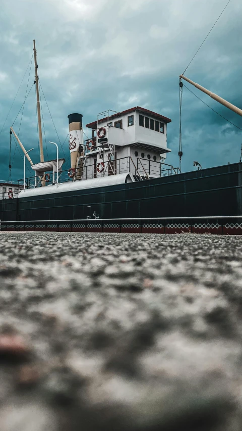 a large boat on the water sitting on land